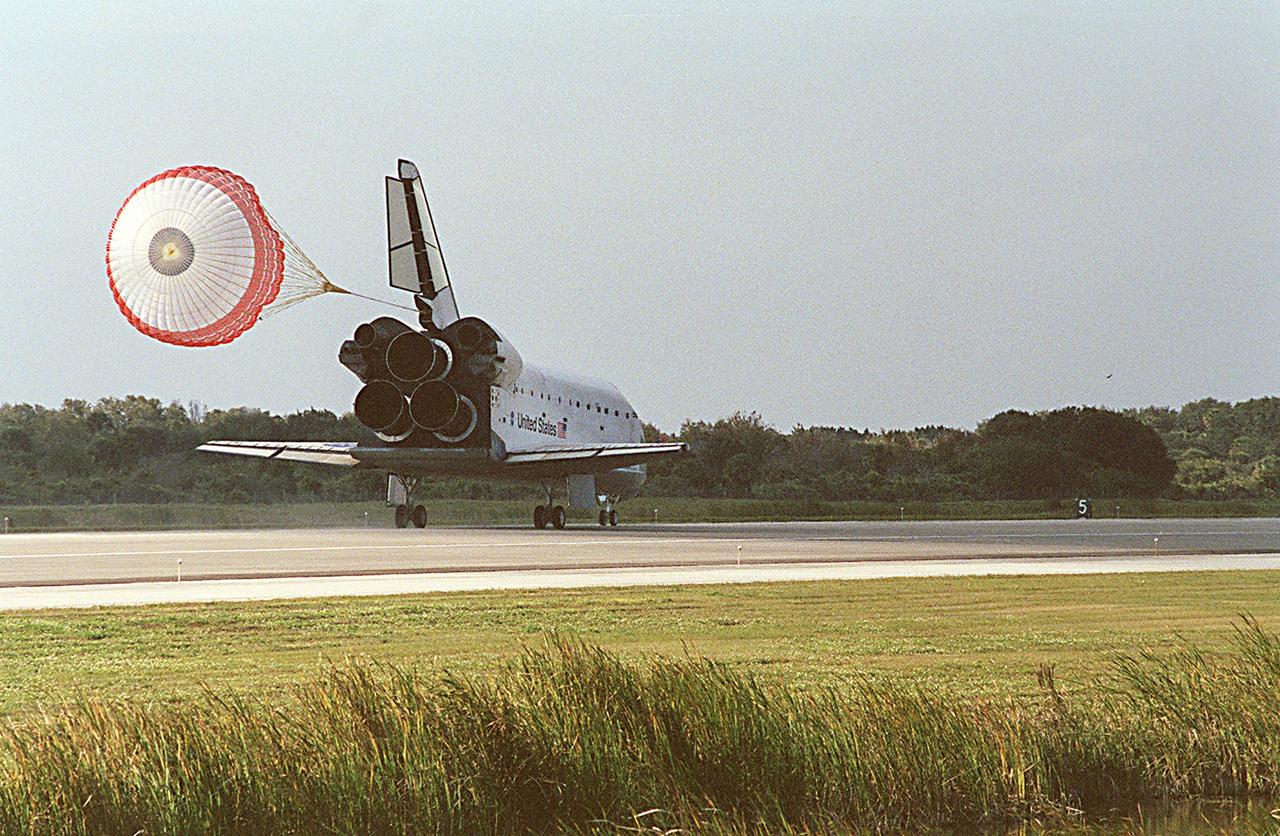KENNEDY SPACE CENTER, FLA. -- The drag chute on Space Shuttle Endeavour unfurls upon landing on runway 33 at the Shuttle Landing Facility, bringing to a close the 13-day, 18-hour, 48-minute, 5.74-million mile STS-113 mission to the International Space Station. Main gear touchdown was at 2:37:12 p.m. EST, nose gear touchdown was at 2:37:23 p.m., and wheel stop was at 2:38:25 p.m. Poor weather conditions thwarted landing opportunities until a fourth day, the first time in Shuttle program history that a landing has been waved off for three consecutive days. The vehicle carries the STS-113 crew, Commander James Wetherbee, Pilot Paul Lockhart and Mission Specialists Michael Lopez-Alegria and John Herrington, as well as the returning Expedition Five crew, Commander Valeri Korzun, ISS Science Officer Peggy Whitson and Flight Engineer Sergei Treschev. The installation of the P1 truss on the International Space Station was accomplished during the mission.