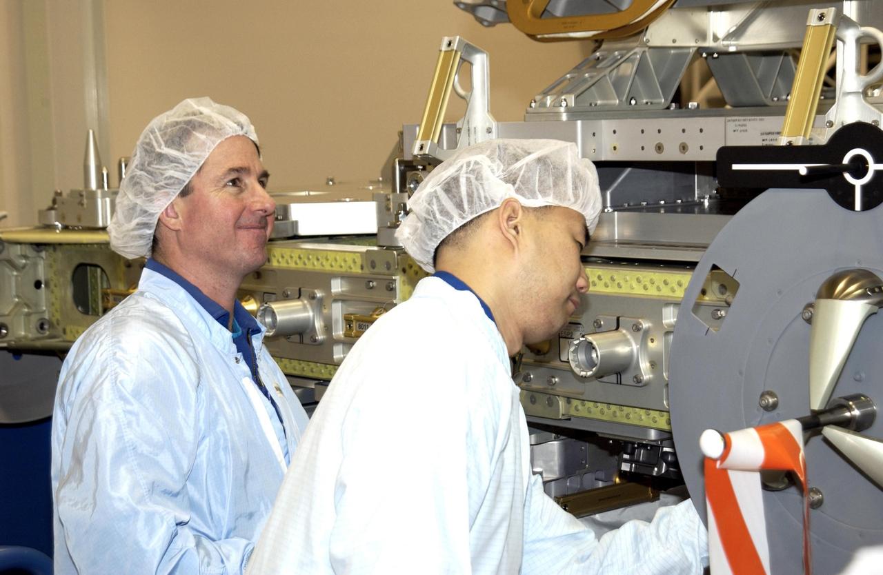 KENNEDY SPACE CENTER, FLA. - At the SPACEHAB facility in Cape Canaveral, STS-114 Mission Specialists Stephen K. Robinson, Ph.D., (left) and Soichi Noguchi, with the National Space Development Agency of Japan (NASDA), participate in familiarization activities with the hardware that will fly on the STS-114 mission. STS-114 is a utilization and logistics flight that will carry Multi-Purpose Logistics Module Raffaello and the External Stowage Platform (ESP-2), as well as the Expedition 7 crew, to the International Space Station. Launch is targeted for March 1, 2003.