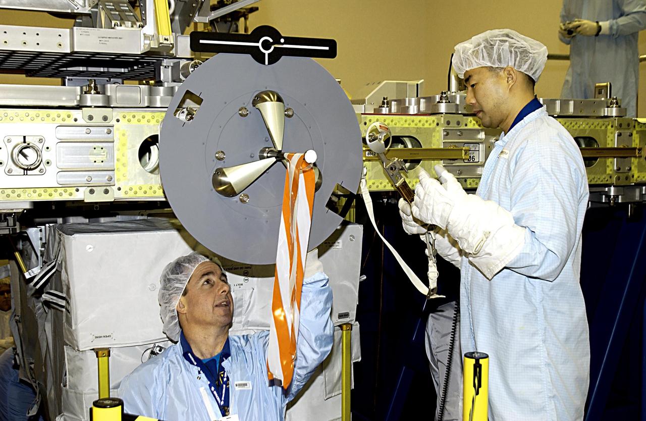 KENNEDY SPACE CENTER, FLA. - At the SPACEHAB facility in Cape Canaveral, STS-114 Mission Specialists Stephen K. Robinson, Ph.D., (left) and Soichi Noguchi, with the National Space Development Agency of Japan (NASDA), participate in familiarization activities with the hardware that will fly on the STS-114 mission. STS-114 is a utilization and logistics flight that will carry Multi-Purpose Logistics Module Raffaello and the External Stowage Platform (ESP-2), as well as the Expedition 7 crew, to the International Space Station. Launch is targeted for March 1, 2003.