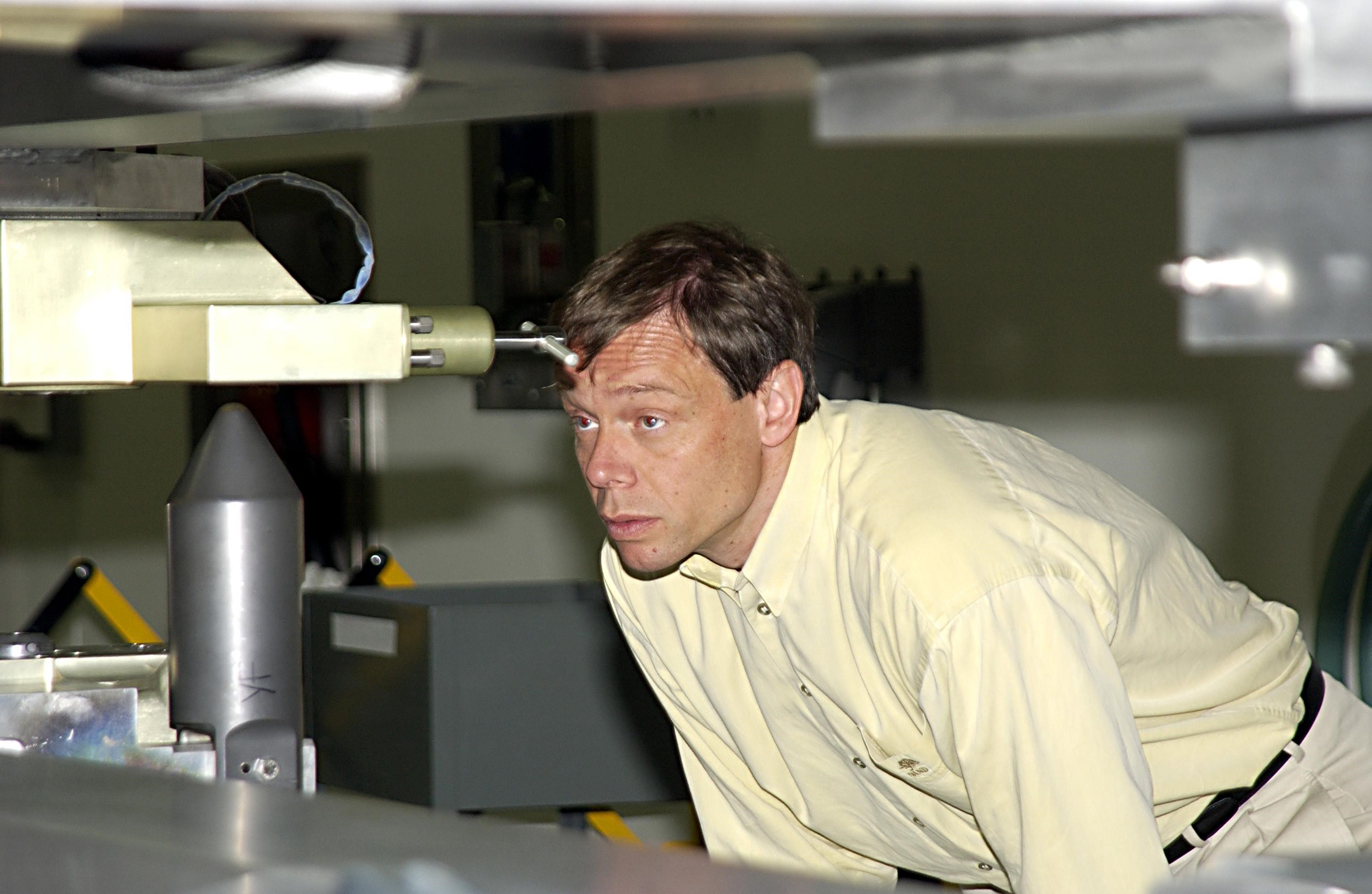 KENNEDY SPACE CENTER, FLA. - In the Space Station Processing Facility, STS-116 Mission Specialist Christer Fuglesang, who is with the European Space Agency, looks over equipment for the mission during a Crew Equipment Interface Test activity. Mission STS-116 is the 19th assembly flight to the International Space Station, delivering the third port truss segment, the P5 Truss, that will be attached to the second port truss segment, the P3/P4 Truss. The mission will also deliver the eighth expedition crew to the ISS and return Expedition 7. STS-116 is scheduled for launch July 24, 2003.