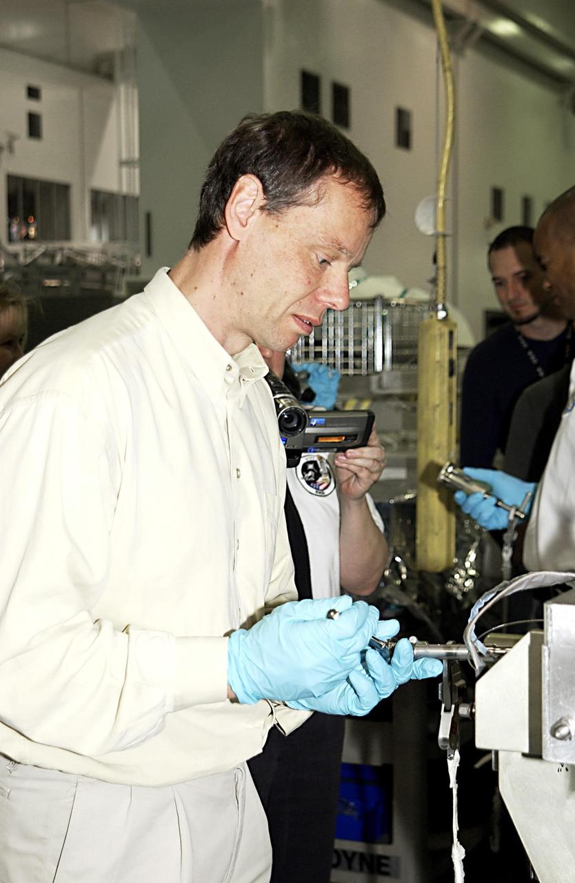 KENNEDY SPACE CENTER, FLA. - In the Space Station Processing Facility, STS-116 Mission Specialist Christer Fuglesang, who is with the European Space Agency, works on equipment for the mission during a Crew Equipment Interface Test activity. Mission STS-116 is the 19th assembly flight to the International Space Station, delivering the third port truss segment, the P5 Truss, that will be attached to the second port truss segment, the P3/P4 Truss. The mission will also deliver the eighth expedition crew to the ISS and return Expedition 7. STS-116 is scheduled for launch July 24, 2003.