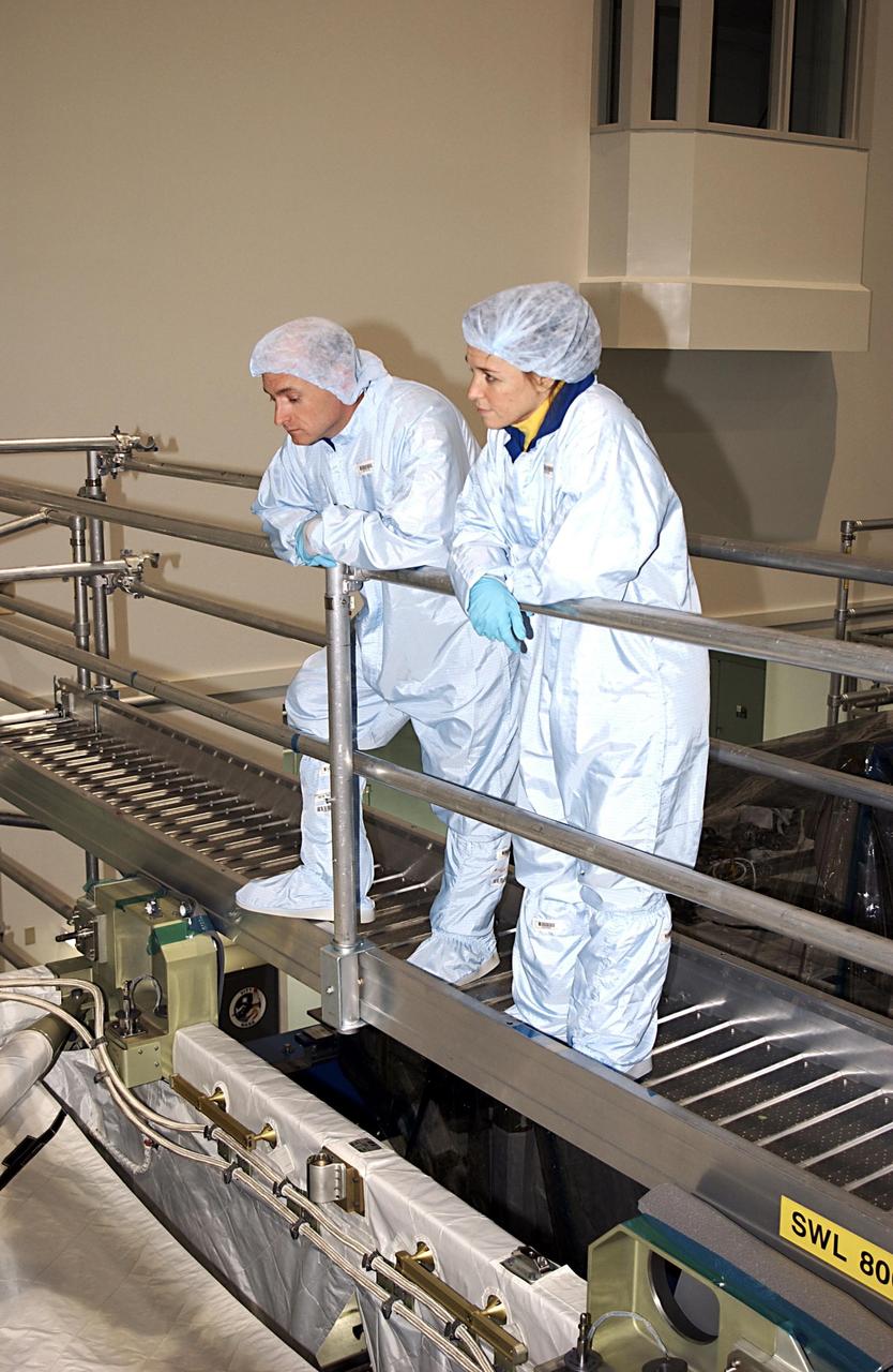 KENNEDY SPACE CENTER, FLA. - STS-118  Commander Scott Kelly  (left) and Mission Specialist Lisa Nowak look over equipment in the Space Station Processing Facility Facility during Crew Equipment Interface Test activities.   The mission to the International Space Station will be delivering the third starboard truss segment, the ITS S5, which will be attached to the station, and a SPACEHAB Single Cargo Module with supplies and equipment.  Launch aboard Space Shuttle Columbia is scheduled for Nov. 13, 2003.   