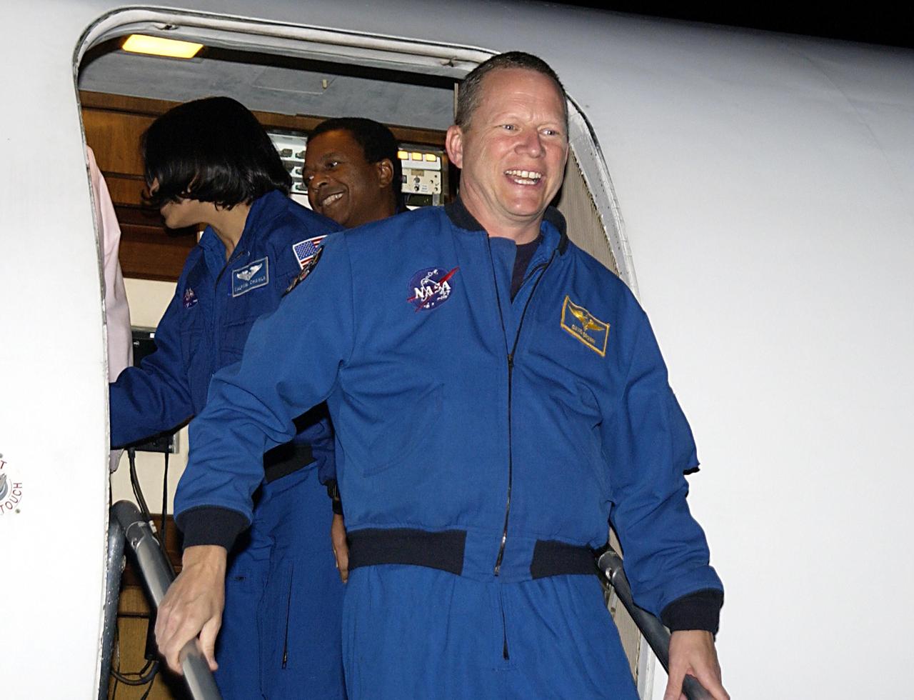KENNEDY SPACE CENTER, FLA. - STS-107 Mission Specialist David Brown shows his pleasure at arriving at KSC for pre-launch preparations.  STS-107 is a mission devoted to research and will include more than 80 experiments that will study Earth and space science, advanced technology development, and astronaut health and safety. The payload on Space Shuttle Columbia includes FREESTAR (Fast Reaction Experiments Enabling Science, Technology, Applications and Research) and the SHI Research Double Module (SHI/RDM), known as SPACEHAB.  Experiments on the module range from material sciences to life sciences.  The crew includes Payload Specialist Ilan Ramon, the first Israeli astronaut.  Other crew members are Commander Rick Husband, Pilot William "Willie" McCool, Payload Commander Michael Anderson and Mission Specialists Kalpana Chawla and Laurel Clark.  Launch of Columbia is targeted for Jan. 16 between 10 a.m. and 2 p.m.