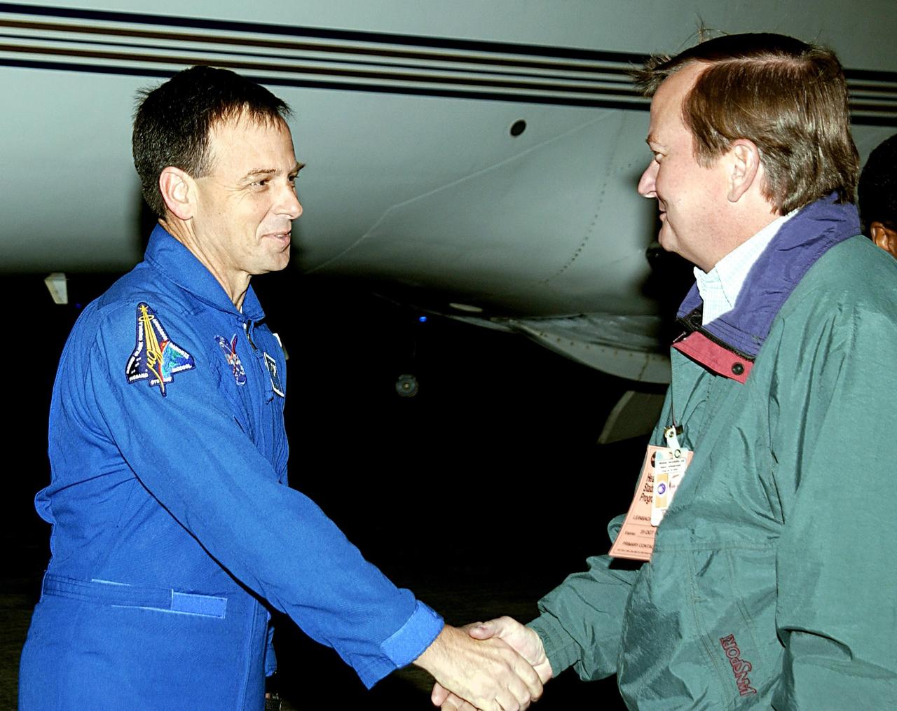 KENNEDY SPACE CENTER, FLA. -- STS-107 Payload Specialist Ilan Ramon (left) is greeted on his arrival by Launch Director Mike Linebach. Ramon is the first Israeli astronaut to fly on a Shuttle mission. STS-107 is a mission devoted to research and will include more than 80 experiments that will study Earth and space science, advanced technology development, and astronaut health and safety. The payload on Space Shuttle Columbia includes FREESTAR (Fast Reaction Experiments Enabling Science, Technology, Applications and Research) and the SHI Research Double Module (SHI/RDM), known as SPACEHAB. Experiments on the module range from material sciences to life sciences. Other crew members are Commander Rick Husband, Pilot William "Willie" McCool, Payload Commander Michael Anderson and Mission Specialists Kalpana Chawla, David Brown and Laurel Clark. Launch of Columbia is targeted for Jan. 16 between 10 a.m. and 2 p.m.