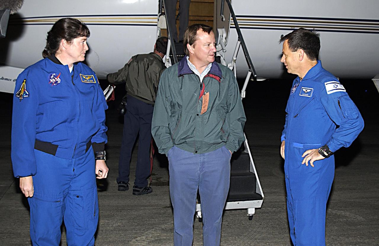 KENNEDY SPACE CENTER, FLA. --  Two members of the STS-107 crew, Mission Specialist Laurel Clark (left) and Payload Specialist Ilan Ramon (right), talk after their arrival at KSC to Launch Director Mike Leinbach. Ramon is the first Israeli astronaut to fly on a Shuttle mission. STS-107 is a mission devoted to research and will include more than 80 experiments that will study Earth and space science, advanced technology development, and astronaut health and safety. The payload on Space Shuttle Columbia includes FREESTAR (Fast Reaction Experiments Enabling Science, Technology, Applications and Research) and the SHI Research Double Module (SHI/RDM), known as SPACEHAB.  Experiments on the module range from material sciences to life sciences.  Other crew members are Commander Rick Husband, Pilot William "Willie" McCool, Payload Commander Michael Anderson and Mission Specialists Kalpana Chawla and David Brown.  Launch of Columbia is targeted for Jan. 16 between 10 a.m. and 2 p.m.