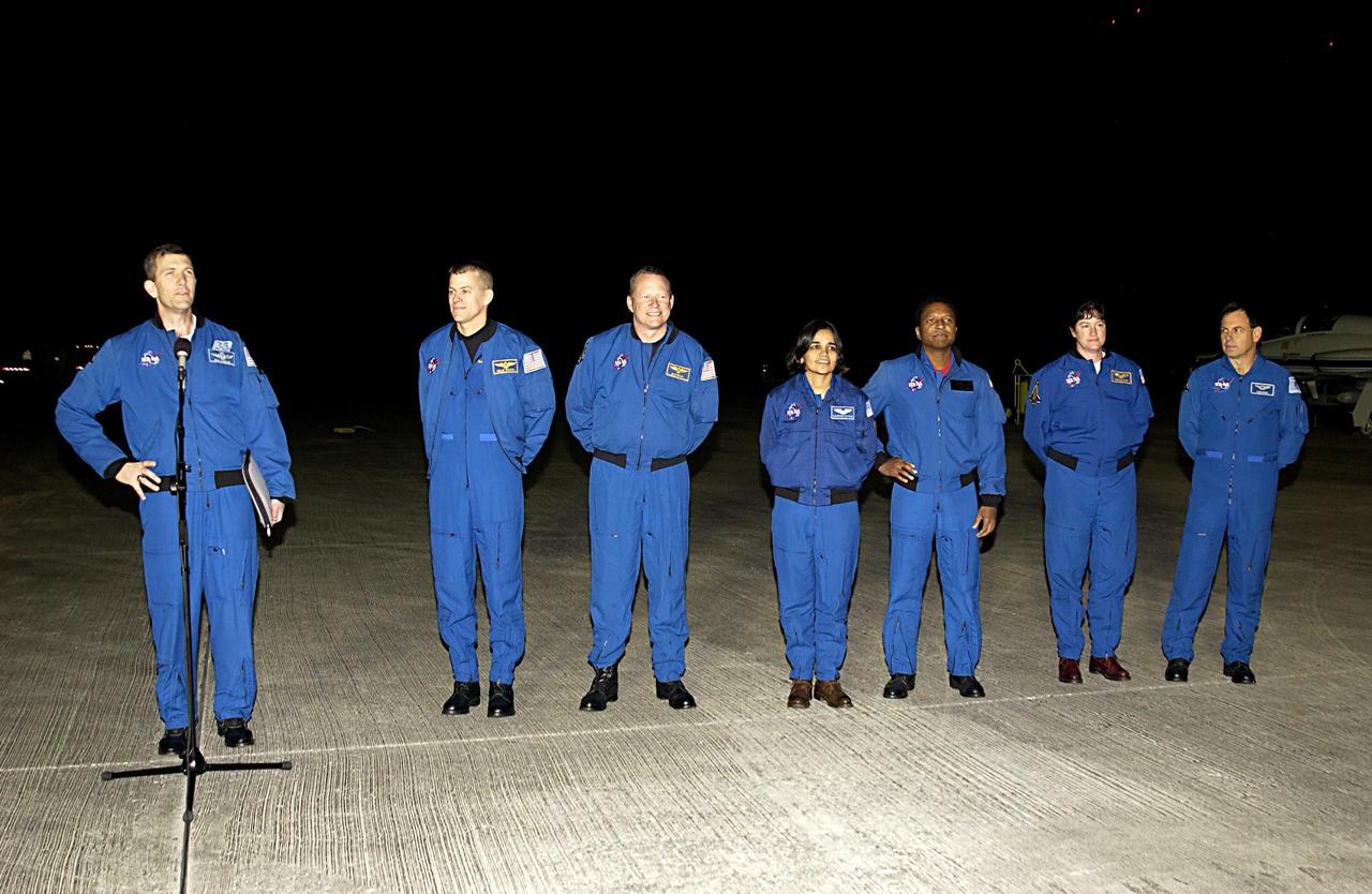 KENNEDY SPACE CENTER, FLA. -STS-107 Commander Rick Husband (at the microphone) makes a few comments after the crew's arrival at KSC for pre-launch preparations.  Standing left to right are Husband, Pilot William "Willie" McCool, Mission Specialists David Brown and Kalpana Chawla, Payload Commander Michael Anderson, Mission Specialist Laurel Clark and Payload Specialist Ilan Ramon, who is the first Israeli astronaut to fly on a Shuttle mission. STS-107 is a mission devoted to research and will include more than 80 experiments that will study Earth and space science, advanced technology development, and astronaut health and safety. The payload on Space Shuttle Columbia includes FREESTAR (Fast Reaction Experiments Enabling Science, Technology, Applications and Research) and the SHI Research Double Module (SHI/RDM), known as SPACEHAB.  Experiments on the module range from material sciences to life sciences. Launch of Columbia is targeted for Jan. 16 between 10 a.m. and 2 p.m.