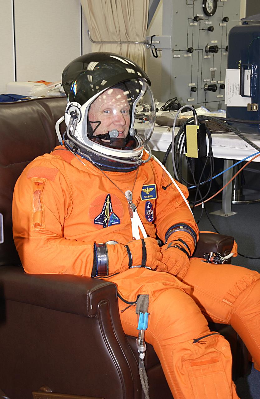 STS-107 Mission Specialist David Brown gets a final suit fit as part of launch preparations. STS-107 is a mission devoted to research and will include more than 80 experiments that will study Earth and space science, advanced technology development, and astronaut health and safety. The payload on Space Shuttle Columbia includes FREESTAR (Fast Reaction Experiments Enabling Science, Technology, Applications and Research) and the SHI Research Double Module (SHI/RDM), known as SPACEHAB. Experiments on the module range from material sciences to life sciences. Launch is scheduled for Jan. 16, between 10 a.m. and 2 p.m.