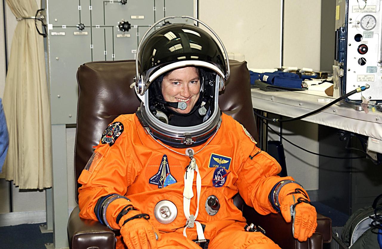 KENNEDY SPACE CENTER, FLA. - STS-107 Mission Specialist Laurel Clark gets a final fitting on her launch and entry suit as part of launch preparations. STS-107 is a mission devoted to research and will include more than 80 experiments that will study Earth and space science, advanced technology development, and astronaut health and safety. The payload on Space Shuttle Columbia includes FREESTAR (Fast Reaction Experiments Enabling Science, Technology, Applications and Research) and the SHI Research Double Module (SHI/RDM), known as SPACEHAB.  Experiments on the module range from material sciences to life sciences.  Launch is scheduled for Jan. 16, between 10 a.m. and 2 p.m.