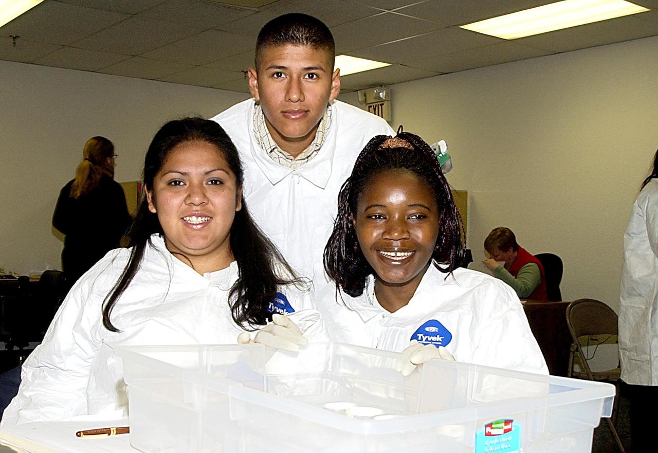 KENNEDY SPACE CENTER, FLA. - Students look over their experiments that will fly in SPACEHAB on Space Shuttle Columbia on mission STS-107. SPACEHAB's complement of commercial experiments includes six educational experiments designed and developed by students in six different countries under the auspices of Space Technology and Research Students (STARS), a global education program managed by SPACEHAB subsidiary Space Media. The countries represented are Australia, China, Israel, Japan, Liechtenstein and the United States. The student investigators who conceived these experiments will monitor their operations in space. The experiments will be housed in BioServe Space Technologies' Isothermal Containment Module (ICM --a small temperature-controlled facility that provides experiment support such as physical containment, lighting, and video imaging) and stowed in a middeck-size locker aboard the SPACEHAB Research Double Module.