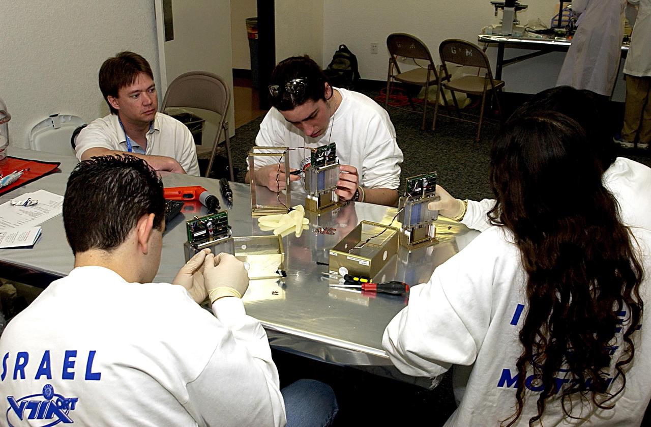 KENNEDY SPACE CENTER, FLA. - Students work on their experiments that will fly in SPACEHAB on Space Shuttle Columbia on mission STS-107. SPACEHAB's complement of commercial experiments includes six educational experiments designed and developed by students in six different countries under the auspices of Space Technology and Research Students (STARS), a global education program managed by SPACEHAB subsidiary Space Media. The countries represented are Australia, China, Israel, Japan, Liechtenstein and the United States. The student investigators who conceived these experiments will monitor their operations in space. The experiments will be housed in BioServe Space Technologies' Isothermal Containment Module (ICM --a small temperature-controlled facility that provides experiment support such as physical containment, lighting, and video imaging) and stowed in a middeck-size locker aboard the SPACEHAB Research Double Module.