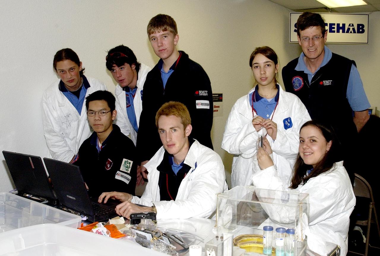KENNEDY SPACE CENTER, FLA. - Students pause during their work on their experiments that will fly in SPACEHAB on Space Shuttle Columbia on mission STS-107. SPACEHAB's complement of commercial experiments includes six educational experiments designed and developed by students in six different countries under the auspices of Space Technology and Research Students (STARS), a global education program managed by SPACEHAB subsidiary Space Media. The countries represented are Australia, China, Israel, Japan, Liechtenstein and the United States. The student investigators who conceived these experiments will monitor their operations in space. The experiments will be housed in BioServe Space Technologies' Isothermal Containment Module (ICM --a small temperature-controlled facility that provides experiment support such as physical containment, lighting, and video imaging) and stowed in a middeck-size locker aboard the SPACEHAB Research Double Module.