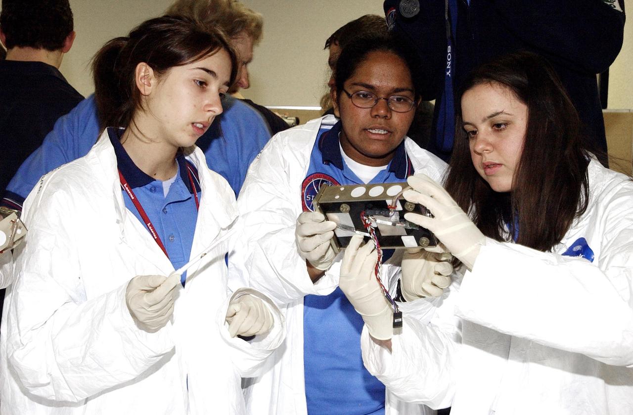 KENNEDY SPACE CENTER, FLA. -- Students work on their experiments that will fly in SPACEHAB on Space Shuttle Columbia on mission STS-107. SPACEHAB's complement of commercial experiments includes six educational experiments designed and developed by students in six different countries under the auspices of Space Technology and Research Students (STARS), a global education program managed by SPACEHAB subsidiary Space Media. The countries represented are Australia, China, Israel, Japan, Liechtenstein and the United States. The student investigators who conceived these experiments will monitor their operations in space. The experiments will be housed in BioServe Space Technologies' Isothermal Containment Module (ICM --a small temperature-controlled facility that provides experiment support such as physical containment, lighting, and video imaging) and stowed in a middeck-size locker aboard the SPACEHAB Research Double Module.