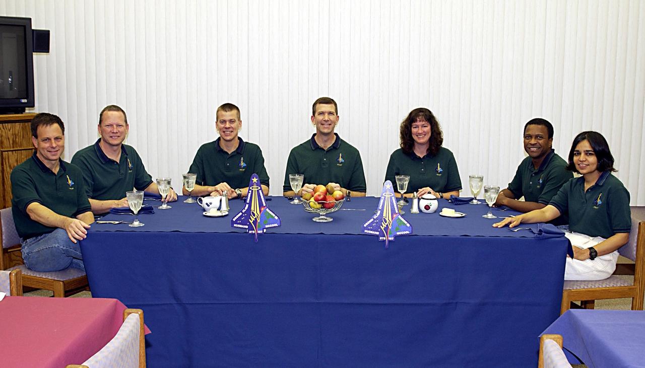 KENNEDY SPACE CENTER, FLA. - The STS-107 crew gathers at breakfast prior to preparing for launch.  Seated left to right are Payload Specialist Ilan Ramon, Mission Specialist David Brown, Pilot William "Willie" McCool, Commander Rick Husband, Mission Specialist Laurel Clark, Payload Commander Michael Anderson and Mission Specialist Kalpana Chawla. STS-107 is a mission devoted to research and will include more than 80 experiments that will study Earth and space science, advanced technology development, and astronaut health and safety. The payload on Space Shuttle Columbia includes FREESTAR (Fast Reaction Experiments Enabling Science, Technology, Applications and Research) and the SHI Research Double Module (SHI/RDM), known as SPACEHAB.  Experiments on the module range from material sciences to life sciences.  Liftoff is scheduled for 10:39 a.m. EST.     