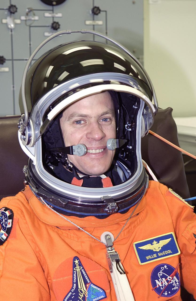 KENNEDY SPACE CENTER, FLA. - STS-107 Pilot William "Willie" McCool shows his pleasure at suiting up for launch. STS-107 is a mission devoted to research and will include more than 80 experiments that will study Earth and space science, advanced technology development, and astronaut health and safety. The payload on Space Shuttle Columbia includes FREESTAR (Fast Reaction Experiments Enabling Science, Technology, Applications and Research) and the SHI Research Double Module (SHI/RDM), known as SPACEHAB.  Experiments on the module range from material sciences to life sciences.  Liftoff is scheduled for 10:39 a.m. EST.