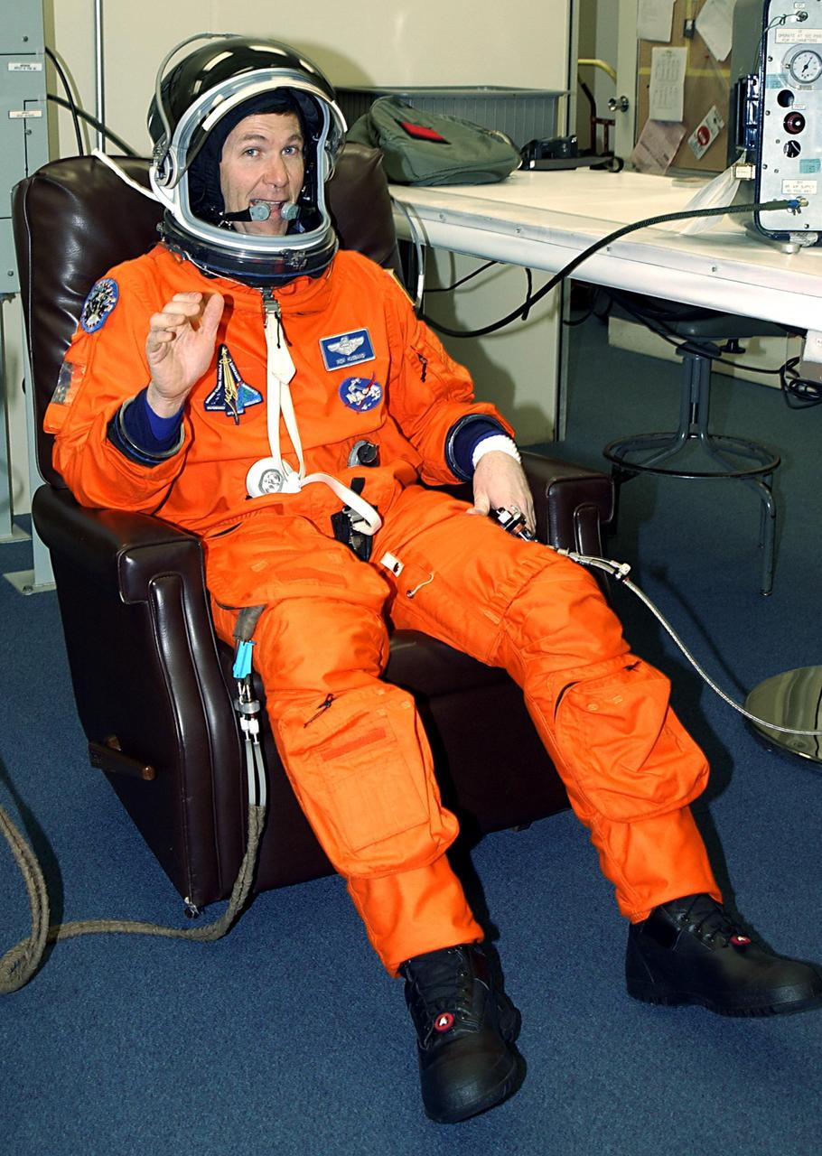 KENNEDY SPACE CENTER, FLA. - STS-107 Mission Commander Rick Husband waves during suitup for launch on mission STS-107. The mission is devoted to research and will include more than 80 experiments that will study Earth and space science, advanced technology development, and astronaut health and safety. The payload on Space Shuttle Columbia includes FREESTAR (Fast Reaction Experiments Enabling Science, Technology, Applications and Research) and the SHI Research Double Module (SHI/RDM), known as SPACEHAB.  Experiments on the module range from material sciences to life sciences.  Liftoff is scheduled for 10:39 a.m. EST.