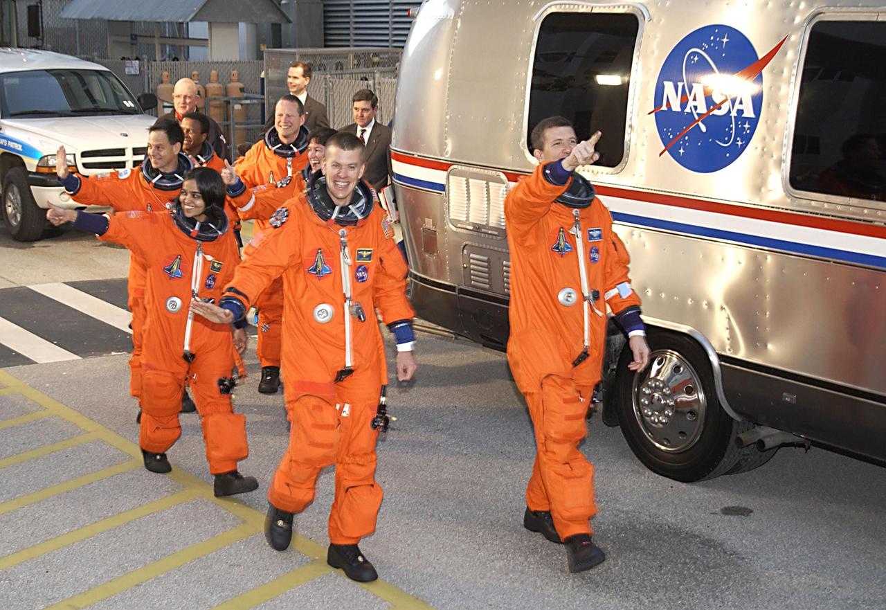 KENNEDY SPACE CENTER, FLA. - The STS-107 crew heads for the Astrovan and a ride to Launch Pad 39A for liftoff. In front, left to right, are Payload Specialist Ilan Ramon, Mission Specialist Kalpana Chawla and Pilot William "Willie" McCool; behind them, left to right, are Payload Commander Michael Anderson, Mission Specialists David Brown and Laurel Clark, and Mission Commander Rick Husband. Ramon is the first astronaut from Israel to fly on a Shuttle. The 16-day mission is devoted to research and will include more than 80 experiments that will study Earth and space science, advanced technology development, and astronaut health and safety. The payload on Space Shuttle Columbia includes FREESTAR (Fast Reaction Experiments Enabling Science, Technology, Applications and Research) and the SHI Research Double Module (SHI/RDM), known as SPACEHAB. Experiments on the module range from material sciences to life sciences. Liftoff is scheduled for 10:39 a.m. EST.