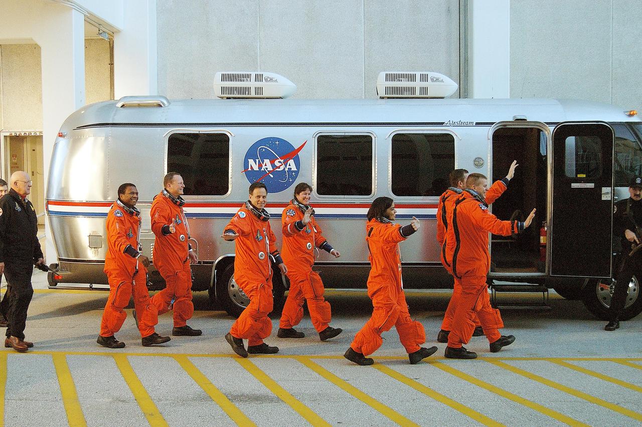 KENNEDY SPACE CENTER, FLA. -- The STS-107 crew heads for the Astrovan and a ride to Launch Pad 39A for liftoff.  From left to right are Payload Commander Michael Anderson, Mission Specialist David Brown, Payload Specialist Ilan Ramon, Mission Specialists Laurel Clark and Kalpana Chawla, Mission Commandaer Rick Husband and Pilot William "Willie" McCool. Ramon is the first astronaut from Israel to fly on a Shuttle. The 16-day mission is devoted to research and will include more than 80 experiments that will study Earth and space science, advanced technology development, and astronaut health and safety. The payload on Space Shuttle Columbia includes FREESTAR (Fast Reaction Experiments Enabling Science, Technology, Applications and Research) and the SHI Research Double Module (SHI/RDM), known as SPACEHAB.  Experiments on the module range from material sciences to life sciences.  Liftoff is scheduled for 10:39 a.m. EST.  [Photo courtesy of Scott Andrews]