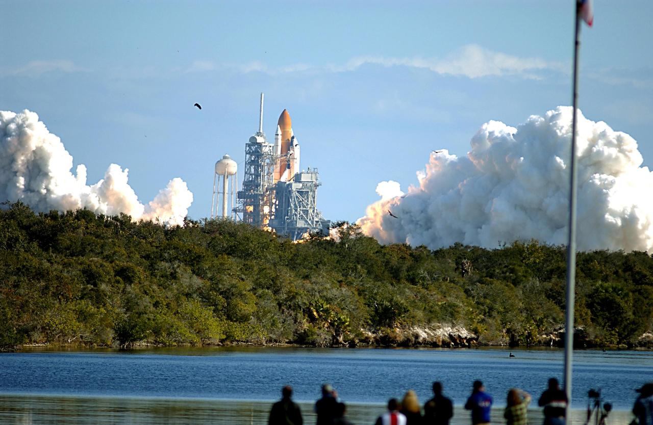 KENNEDY SPACE CENTER, FLA. --  Photographers and spectators watch from across the turn basin as Space Shuttle Columbia begins a perfect launch from Pad 39A following a flawless and uneventful countdown.  Liftoff occurred on-time at 10:39 a.m. EST.  The 16-day research mission will include FREESTAR (Fast Reaction Experiments Enabling Science, Technology, Applications and Research) and the SHI Research Double Module (SHI/RDM), known as SPACEHAB.  Experiments on the module range from material sciences to life sciences. Landing is scheduled at about 8:53 a.m. EST on Saturday, Feb. 1.  This mission is the first Shuttle mission of 2003. Mission STS-107 is the 28th flight of the orbiter Columbia and the 113th flight overall in NASA's Space Shuttle program. 