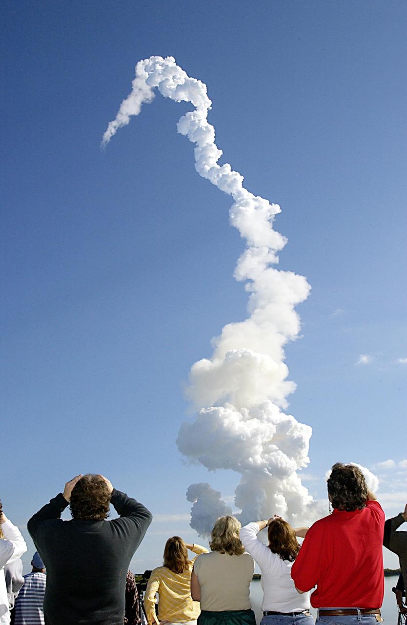 KENNEDY SPACE CENTER, FLA. -- After a perfect launch, spectators try to catch a last glimpse of Space Shuttle Columbia, barely visible at the top end of the twisted column of smoke. Following a flawless and uneventful countdown, liftoff occurred on-time at 10:39 a.m. EST. Headed for a 16-day research mission, Columbia's crew will be taking part in more than 80 experiment, including FREESTAR (Fast Reaction Experiments Enabling Science, Technology, Applications and Research) and the SHI Research Double Module (SHI/RDM), known as SPACEHAB. Experiments on the module range from material sciences to life sciences. This mission is the first Shuttle mission of 2003. Mission STS-107 is the 28th flight of the orbiter Columbia and the 113th flight overall in NASA's Space Shuttle program.