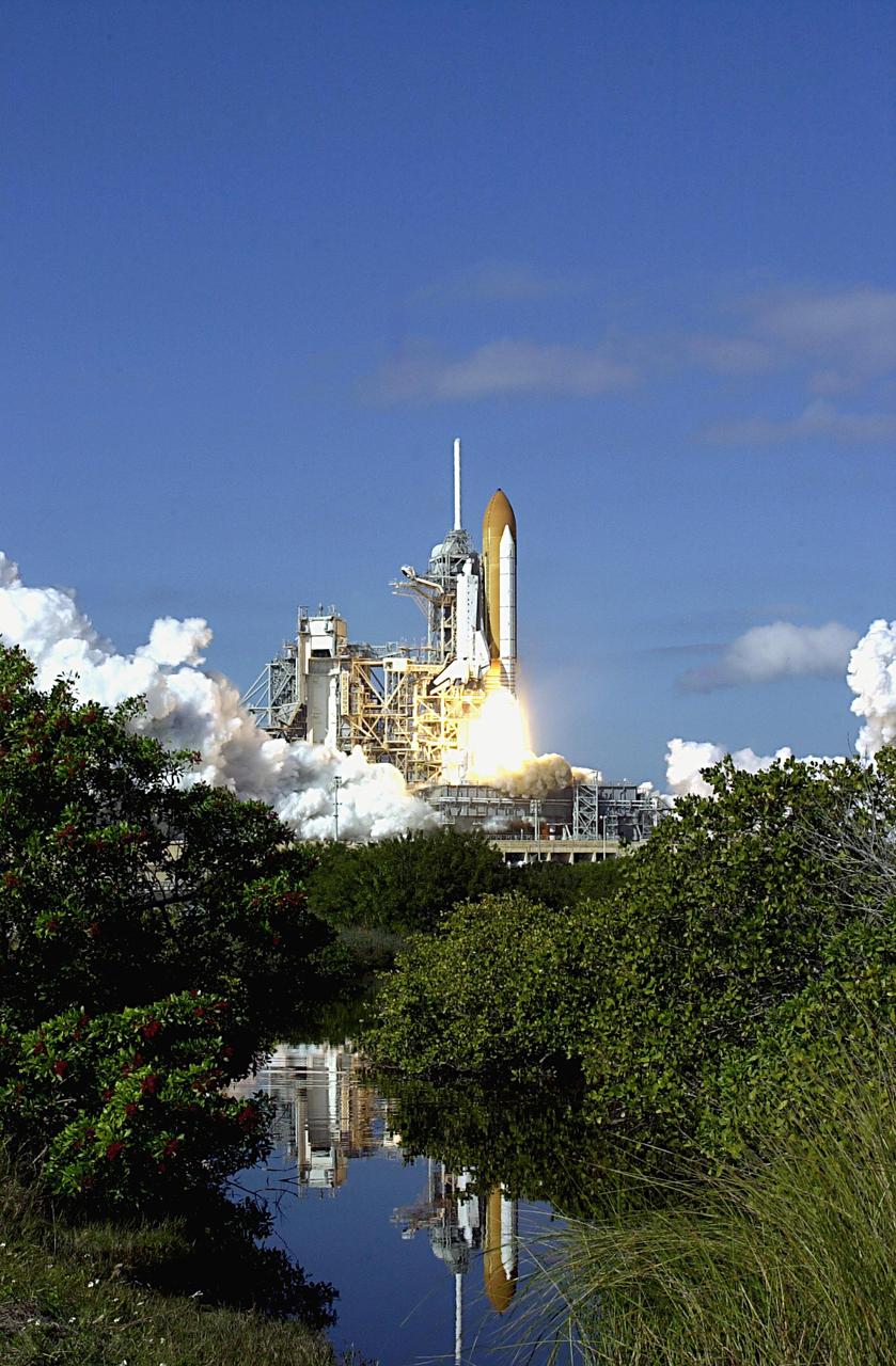 KENNEDY SPACE CENTER, FLA. --  A mirror image in nearby water reflects the perfect launch of Space Shuttle Columbia on a perfect Florida day. Following a flawless and uneventful countdown, liftoff of the Shuttle on mission STS-107 occurred on-time at 10:39 a.m. EST.  The 16-day research mission will include FREESTAR (Fast Reaction Experiments Enabling Science, Technology, Applications and Research) and the SHI Research Double Module (SHI/RDM), known as SPACEHAB.  Experiments on the module range from material sciences to life sciences..  Landing of Columbia is scheduled at about 8:53 a.m. EST on Saturday, Feb. 1.  This mission is the first Shuttle mission of 2003. Mission STS-107 is the 28th flight of the orbiter Columbia and the 113th flight overall in NASA's Space Shuttle program.