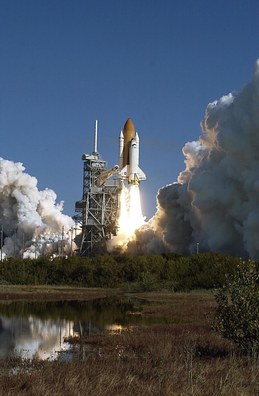 KENNEDY SPACE CENTER, FLA. -- A mirror image in nearby water reflects the perfect launch of Space Shuttle Columbia on a perfect Florida day. Following a flawless and uneventful countdown, liftoff of the Shuttle on mission STS-107 occurred on-time at 10:39 a.m. EST.  The 16-day research mission will include FREESTAR (Fast Reaction Experiments Enabling Science, Technology, Applications and Research) and the SHI Research Double Module (SHI/RDM), known as SPACEHAB.  Experiments on the module range from material sciences to life sciences..  Landing of Columbia is scheduled at about 8:53 a.m. EST on Saturday, Feb. 1.  This mission is the first Shuttle mission of 2003. Mission STS-107 is the 28th flight of the orbiter Columbia and the 113th flight overall in NASA's Space Shuttle program.