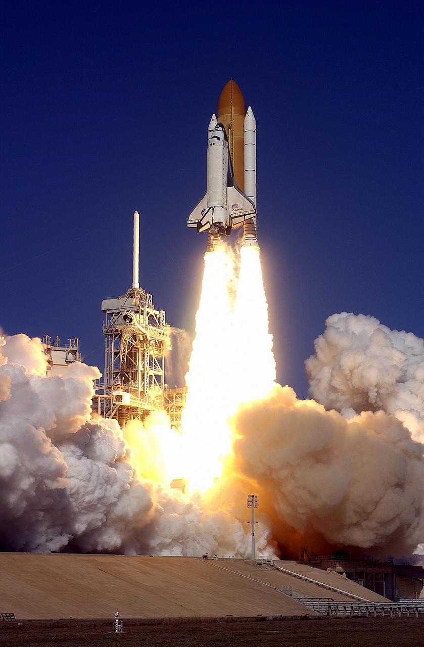 KENNEDY SPACE CENTER, FLA. --  Spewing flames and billowing clouds of smoke across Launch Pad 39A, Space Shuttle Columbia roars toward space on mission STS-107. Following a flawless and uneventful countdown, liftoff occurred on-time at 10:39 a.m. EST.  The 16-day research mission will include FREESTAR (Fast Reaction Experiments Enabling Science, Technology, Applications and Research) and the SHI Research Double Module (SHI/RDM), known as SPACEHAB.  Experiments on the module range from material sciences to life sciences..  Landing of Columbia is scheduled at about 8:53 a.m. EST on Saturday, Feb. 1.  This mission is the first Shuttle mission of 2003. Mission STS-107 is the 28th flight of the orbiter Columbia and the 113th flight overall in NASA's Space Shuttle program.  [Photo courtesy of Scott Andrews]