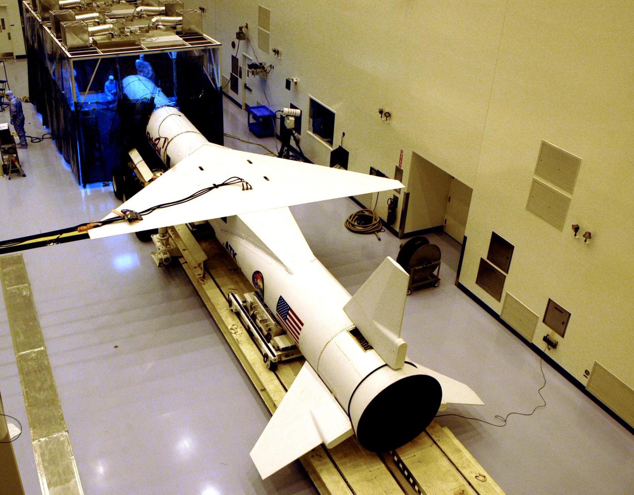 KENNEDY SPACE CENTER, FLA. -- In the Multi-Purpose Processing Facility, the Pegasus XL launch vehicle is ready to be moved toward the Solar Radiation and Climate Experiment (SORCE) satellite in front of it. Built by Orbital Sciences Corporation (OSC), SORCE will study and measure solar irradiance as a source of energy in the Earth's atmosphere. The launch of SORCE is scheduled for Jan. 25 at 3:14 p.m. from Cape Canaveral Air Force Station, Fla. The drop of the Pegasus will be from OSC's L-1011 aircraft at an altitude of 39,000 feet over the Atlantic Ocean approximately 100 miles east-southeast of Cape Canaveral.