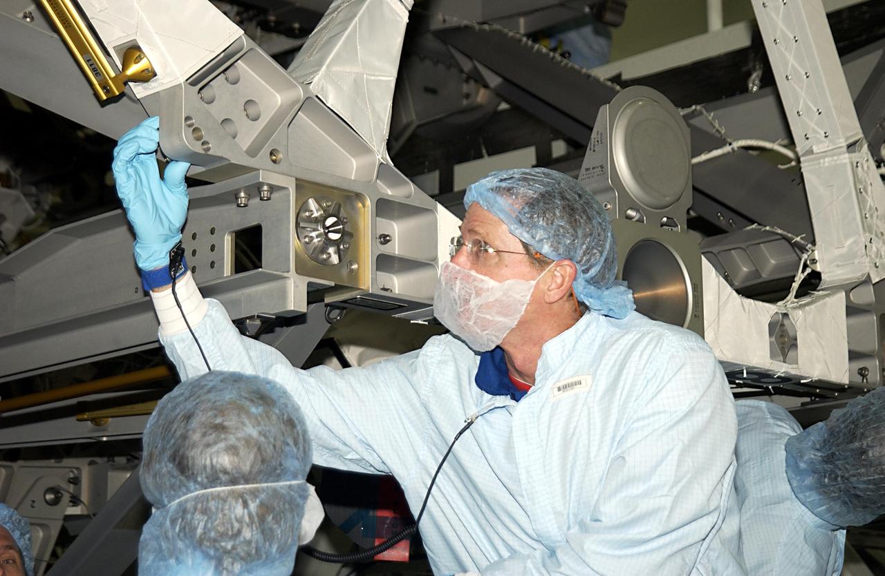 KENNEDY SPACE CENTER, FLA. - Members of the STS-115 crew take part in Crew Equipment Interface Test activities in the Space Station Processing Facility. Checking out part of the payload is Mission Specialist Joseph Tanner. The mission will deliver the second port truss segment, the P3/P4 Truss, to attach to the first port truss segment, the P1 Truss, as well as deploy solar array set 2A and 4A. Launch on Space Shuttle Endeavour is scheduled for May 23, 2003.
