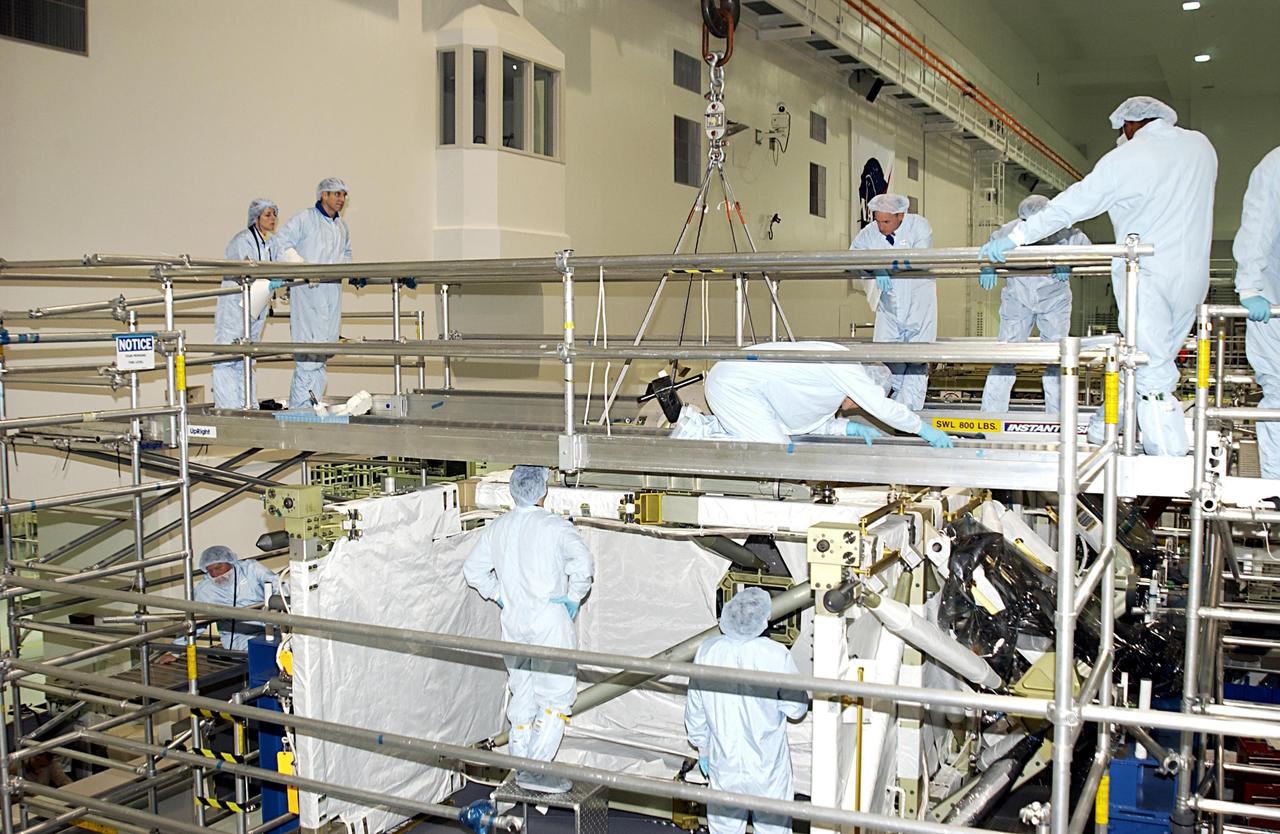 KENNEDY SPACE CENTER, FLA. - The STS-118 crew look over parts of the mission payload in the Space Station Processing Facility. The crew comprises Commander Scott Kelly, Pilot Charles Hobaugh, and Mission Specialists Scott Parazynski, Dafydd Williams, Barbara Morgan and Lisa Nowak. Williams is with the Canadian Space Agency. Morgan was selected by NASA in January 1998 as the first Educator Astronaut. The mission will be delivering the third starboard truss segment, the ITS S5, to the International Space Station, and a SPACEHAB Single Cargo Module with supplies and equipment. Launch aboard Space Shuttle Columbia is scheduled for Nov. 13, 2003.