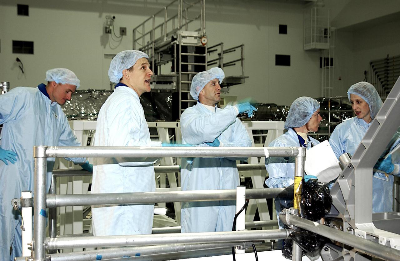 KENNEDY SPACE CENTER, FLA. - Members of the STS-118 crew look over equipment in the Space Station Processing Facility.  Second from left is Mission Specialist Scott Parazynski, next is Pilot Charles Hobaugh and Mission Specialist Barbara Morgan. The mission will be delivering the third starboard truss segment, the ITS S5, to the International Space Station, and a SPACEHAB Single Cargo Module with supplies and equipment.  Launch aboard Space Shuttle Columbia is scheduled for Nov. 13, 2003.  