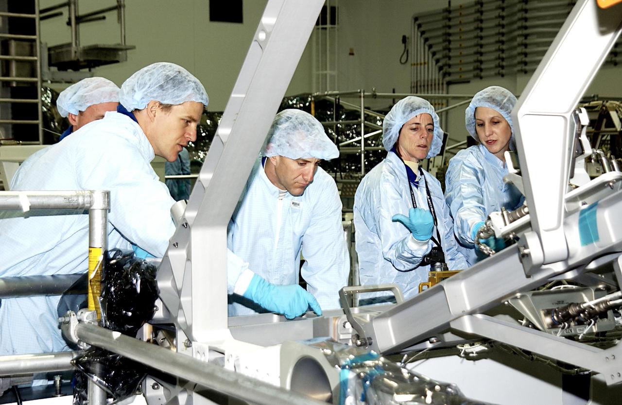 KENNEDY SPACE CENTER, FLA. -- In the Space Station Processing Facility, members of the STS-118 crew look over part of the mission payload.   From left are Mission Specialist Scott Parazynski, Pilot Charles Hobaugh and Mission Specialist Barbara Morgan.  At right is a technician.  Morgan was selected by NASA in January 1998 as the first Educator Astronaut.  The mission will be delivering the third starboard truss segment, the ITS S5, to the International Space Station, and a SPACEHAB Single Cargo Module with supplies and equipment.  Launch aboard Space Shuttle Columbia is scheduled for Nov. 13, 2003.  