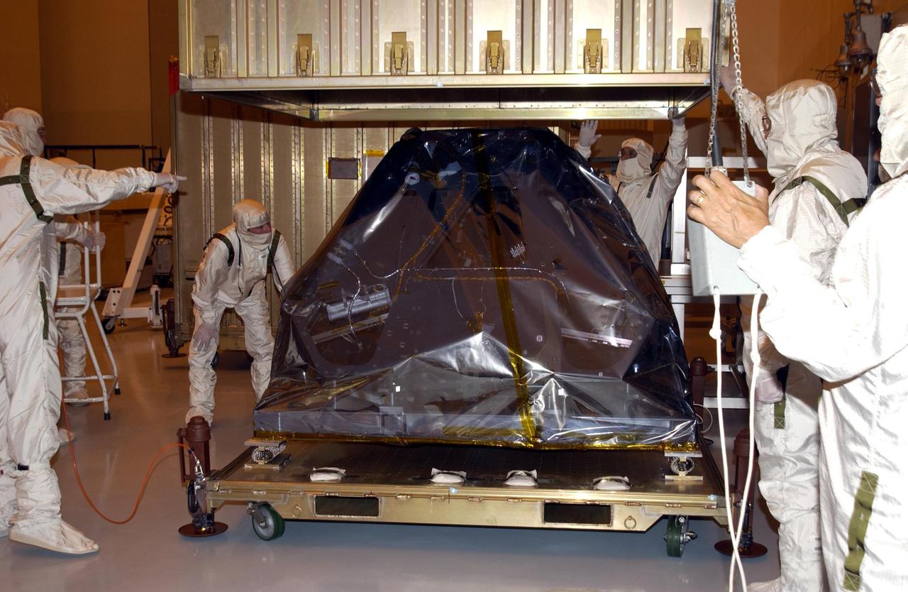 KENNEDY SPACE CENTER, FLA. - In the Payload Hazardous Servicing Facility, workers lift the cover from the Mars Exploration Rover -2. Set to launch in 2003, the Mars Exploration Rover Mission will consist of two identical rovers designed to cover roughly 110 yards (100 meters) each Martian day. Each rover will carry five scientific instruments that will allow it to search for evidence of liquid water that may have been present in the planet's past.  The rovers will be identical to each other, but will land at different regions of Mars.  The first rover has a launch window opening May 30, 2003, and the second rover a window opening June 25, 2003.