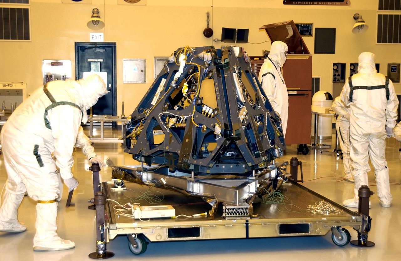 KENNEDY SPACE CENTER, FLA. - Workers in the Payload Hazardous Servicing Facility move the Mars Exploration Rover -2 to a workstand in the high bay. Set to launch in 2003, the Mars Exploration Rover Mission will consist of two identical rovers designed to cover roughly 110 yards (100 meters) each Martian day. Each rover will carry five scientific instruments that will allow it to search for evidence of liquid water that may have been present in the planet's past.  The rovers will be identical to each other, but will land at different regions of Mars.  The first rover has a launch window opening May 30, 2003, and the second rover a window opening June 25, 2003.