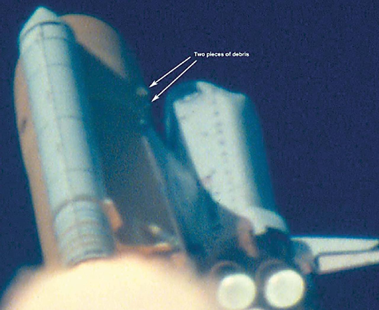 KENNEDY SPACE CENTER, FLA. - At approximately 81-82 seconds after T-0 and liftoff of Space Shuttle Columbia, debris originating from the area near the external tank -Y bipod strut attachpoint is observed striking the underside of the LH wing of the orbiter.  The impact site appears to be near the leading edge of the wing.  Damage assessment is difficult due to poor resolution and analysis is continuing on this event.            