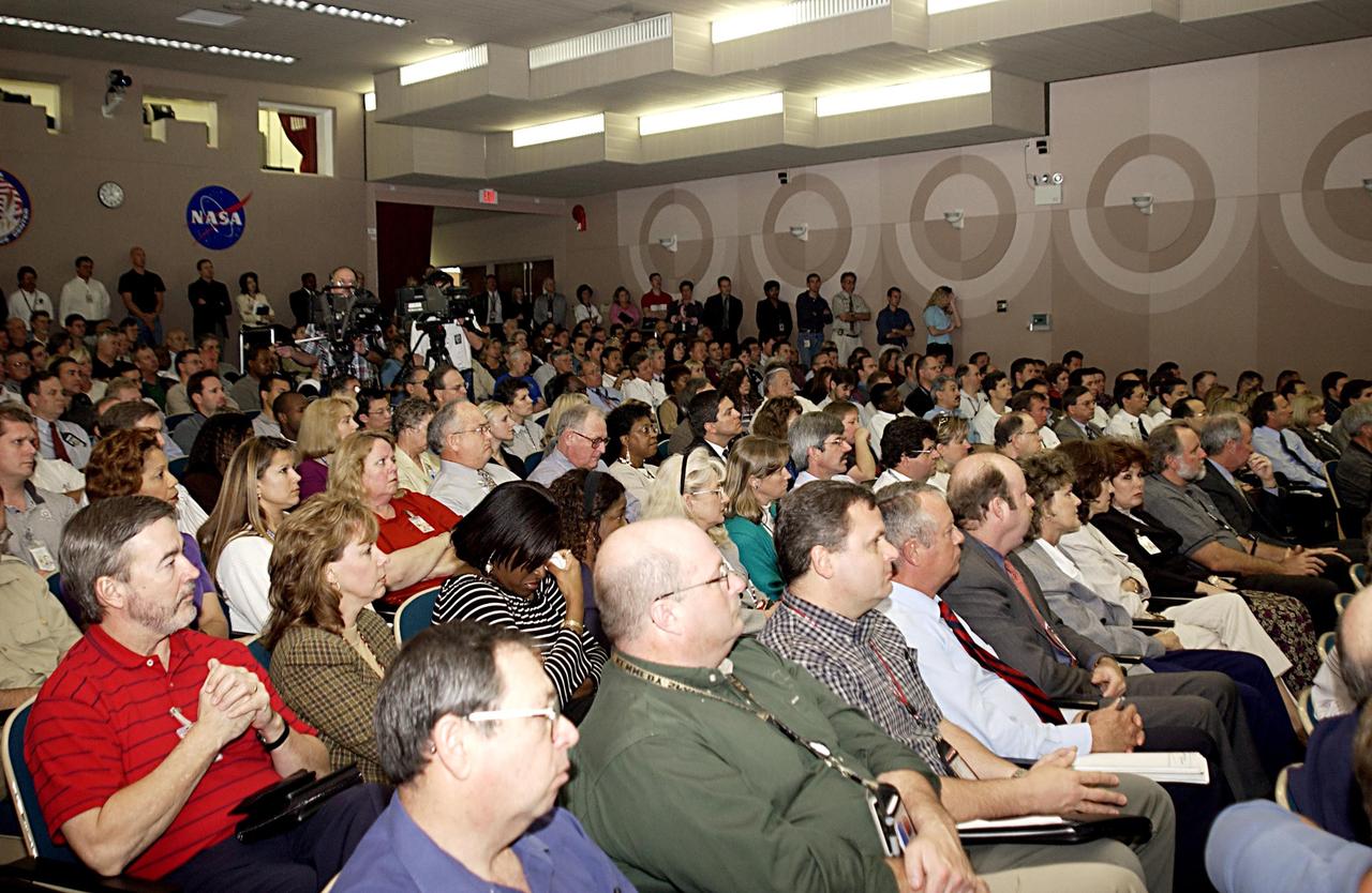 KENNEDY SPACE CENTER, FLA. - Employees listen solemnly as  Center Director Roy Bridges speaks about the tragedy of the loss of Columbia and crew, the impact on the KSC family and, ultimately, the need to honor the fallen heroes by continuing the journey into space.  
