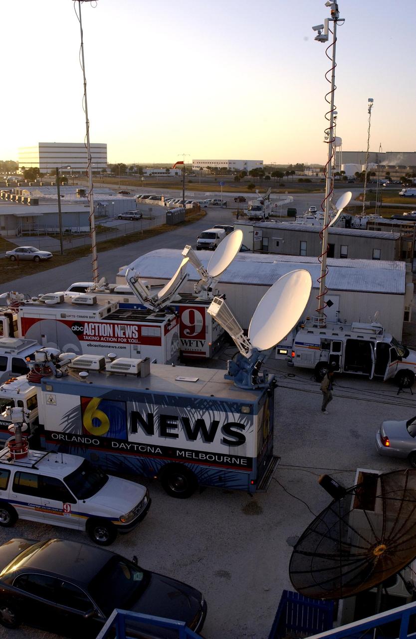 KENNEDY SPACE CENTER, FLA. -- - Media trucks with live satellite feeds fill the top of the mound where the NASA News Center is located. The media are reporting the tragic loss of Space Shuttle Columbia as it was returning to Earth on mission STS-107. Journalists from around the world covered the event.