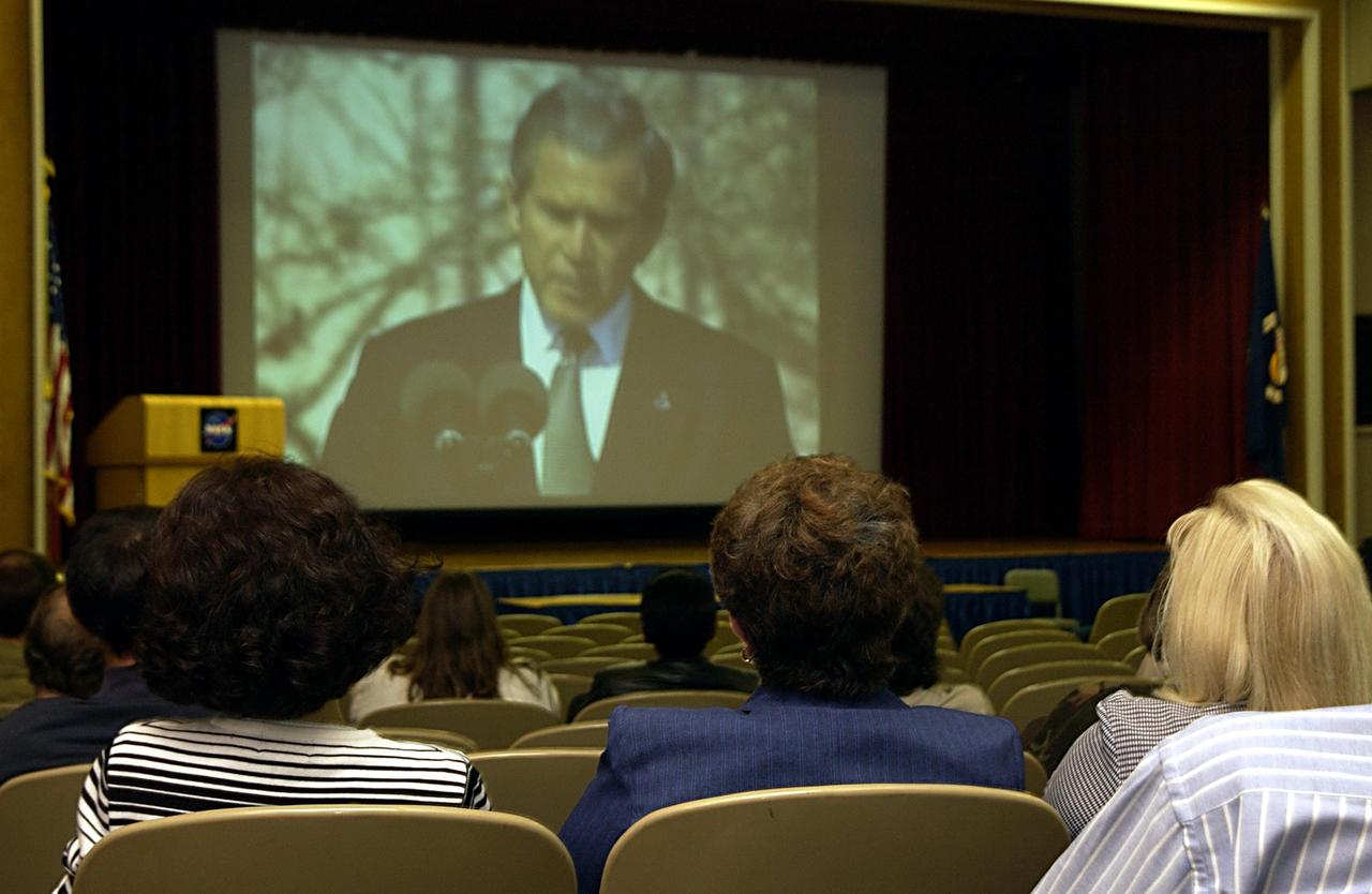KENNEDY SPACE CENTER, FLA. - Employees at KSC watch President George Bush on NASA television as he speaks at the memorial service for the fallen seven astronauts of Columbia bieng held at Johnson Space Center, Houston.      .  