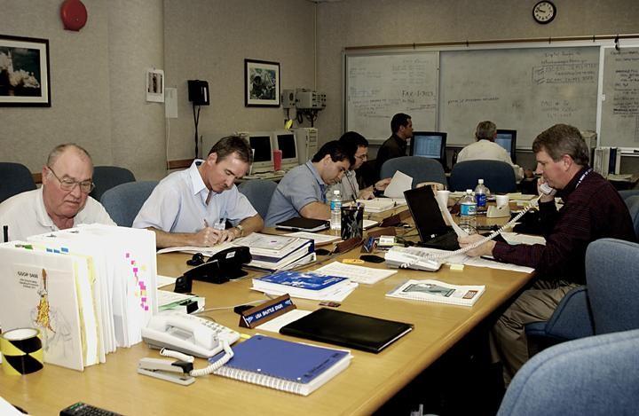 KENNEDY SPACE CENTER, FLA. --  Members of the Recovery Management Team at KSC are at work in the Operations Support Building. They are part of the investigation into the accident that claimed orbiter Columbia and her crew of seven on Feb. 1, 2003, over East Texas as they returned to Earth after a 16-day research mission.  From left around the table are Don Maxwell, Safety, United Space Alliance (USA); Russ DeLoach, chief, Shuttle Mission Assurance Branch, NASA; George Jacobs, Shuttle Engineering; Jeff Campbell, Shuttle Engineering; Dave Rainer, Launch and Landing Operations; and the two co-chairs of the Response Management Team, Denny Gagen, Landing Recovery Manager, and Chris Hasselbring, Landing Operations, USA.  The team is coordinating KSC technical support and assets to the Mishap Investigation Team in Barksdale, La., and providing support for the Recovery teams in Los Angeles, Texas, New Mexico, Arizona and California.  In addition, the team is following up on local leads pertaining to potential debris in the KSC area.         .  