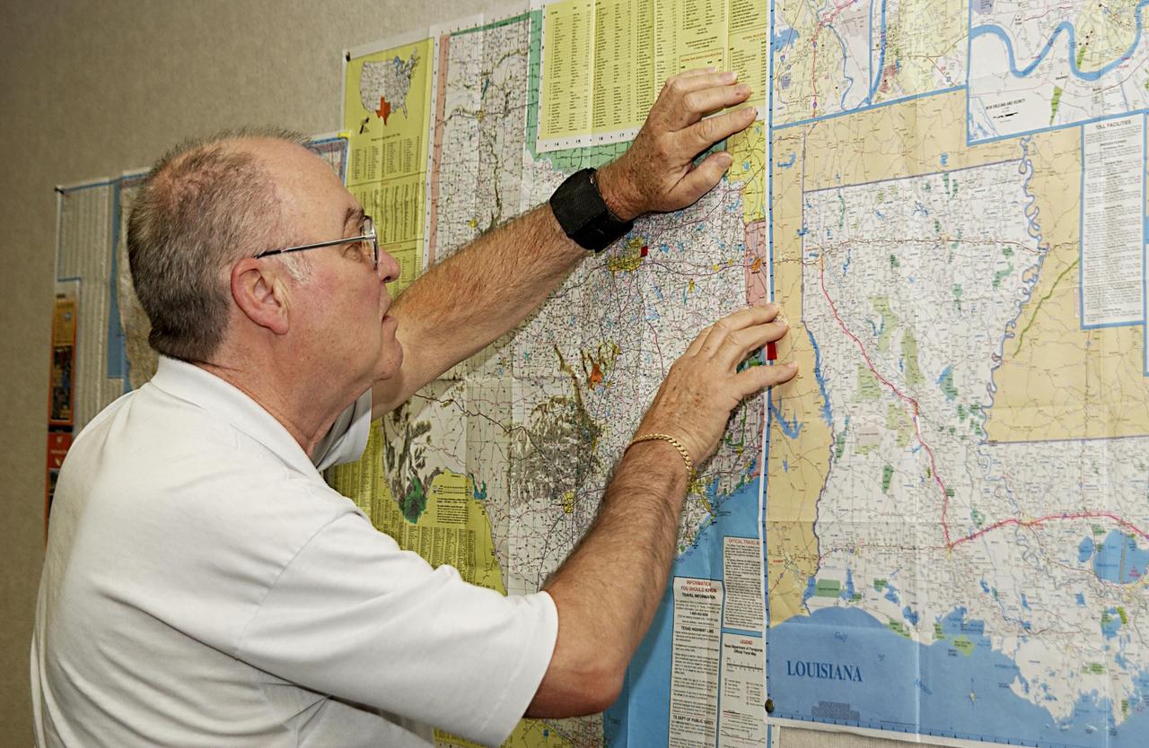 KENNEDY SPACE CENTER, FLA. - Don Maxwell, Safety, United Space Alliance, checks a map of Texas during a meeting of the Recovery Management Team at KSC. The team is part of the investigation into the accident that claimed orbiter Columbia and her crew of seven on Feb. 1, 2003, over East Texas as they returned to Earth after a 16-day research mission. Other team members are Russ DeLoach, chief, Shuttle Mission Assurance Branch, NASA; George Jacobs, Shuttle Engineering; Jeff Campbell, Shuttle Engineering; Dave Rainer, Launch and Landing Operations; the two co-chairs of the Response Management Team, Denny Gagen, Landing Recovery Manager, Chris Hasselbring, Landing Operations, USA; and Larry Ulmer, Safety, NASA. The team is coordinating KSC technical support and assets to the Mishap Investigation Team in Barksdale, La., and providing support for the Recovery teams in Los Angeles, Texas, New Mexico, Arizona and California. In addition, the team is following up on local leads pertaining to potential debris in the KSC area. .