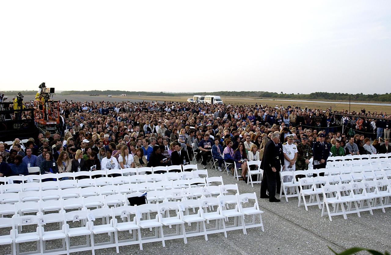 KENNEDY SPACE CENTER, FLA. - Employees at KSC gather at the Shuttle Landing Facility for a Columbia Crew Memorial Service.  The Columbia and her crew of seven were lost on Feb. 1, 2003, over East Texas as they returned to Earth after a 16-day research mission.  Taking part in the service were NASA Administrator Sean O’Keefe, former KSC Director Robert Crippen, astronaut Jim Halsell, several employees, area clergymen, and members of Patrick Air Force Base.  The service concluded with a “Missing Man Formation Fly Over” by NASA T-38 jet aircraft.