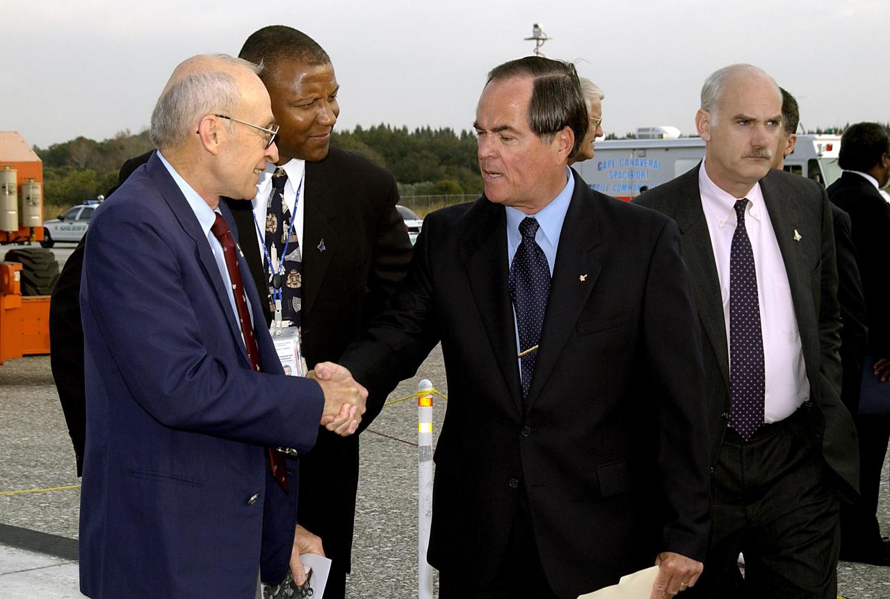 KENNEDY SPACE CENTER, FLA. -  A Columbia Crew Memorial Service is held at the Shuttle Landing Facility for KSC employees and invited guests, including former astronaut and KSC Director Robert Crippen (center).  The Columbia and her crew of seven were lost on Feb. 1, 2003, over East Texas as they returned to Earth after a 16-day research mission.  Taking part in the service were NASA Administrator Sean O’Keefe, former KSC Director Robert Crippen, astronaut Jim Halsell, several employees, area clergymen, and members of Patrick Air Force Base.  The service concluded with a “Missing Man Formation Fly Over” by NASA T-38 jet aircraft.