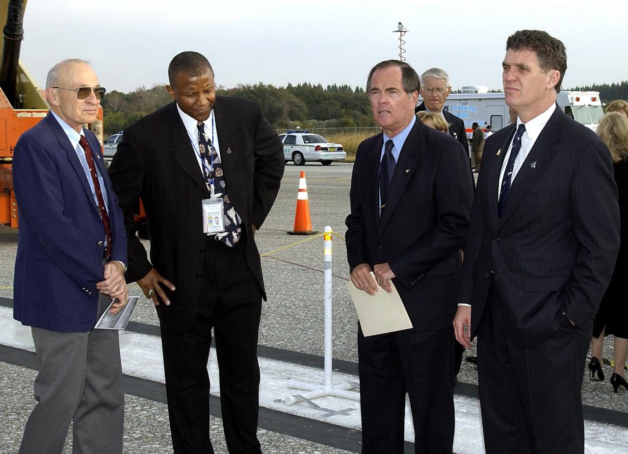 KENNEDY SPACE CENTER, FLA. -  A Columbia Crew Memorial Service is held at the Shuttle Landing Facility for KSC employees and invited guests, including former KSC Director of Shuttle Processing Robert Sieck (left), KSC lead vehicle manager Kelvin Manning (next), and Columbia's first pilot and former KSC Director Robert Crippen (third from left).  The Columbia and her crew of seven were lost on Feb. 1, 2003, over East Texas as they returned to Earth after a 16-day research mission.  Taking part in the service were NASA Administrator Sean O’Keefe, former KSC Director Robert Crippen, astronaut Jim Halsell, several employees, area clergymen, and members of Patrick Air Force Base.  The service concluded with a “Missing Man Formation Fly Over” by NASA T-38 jet aircraft.