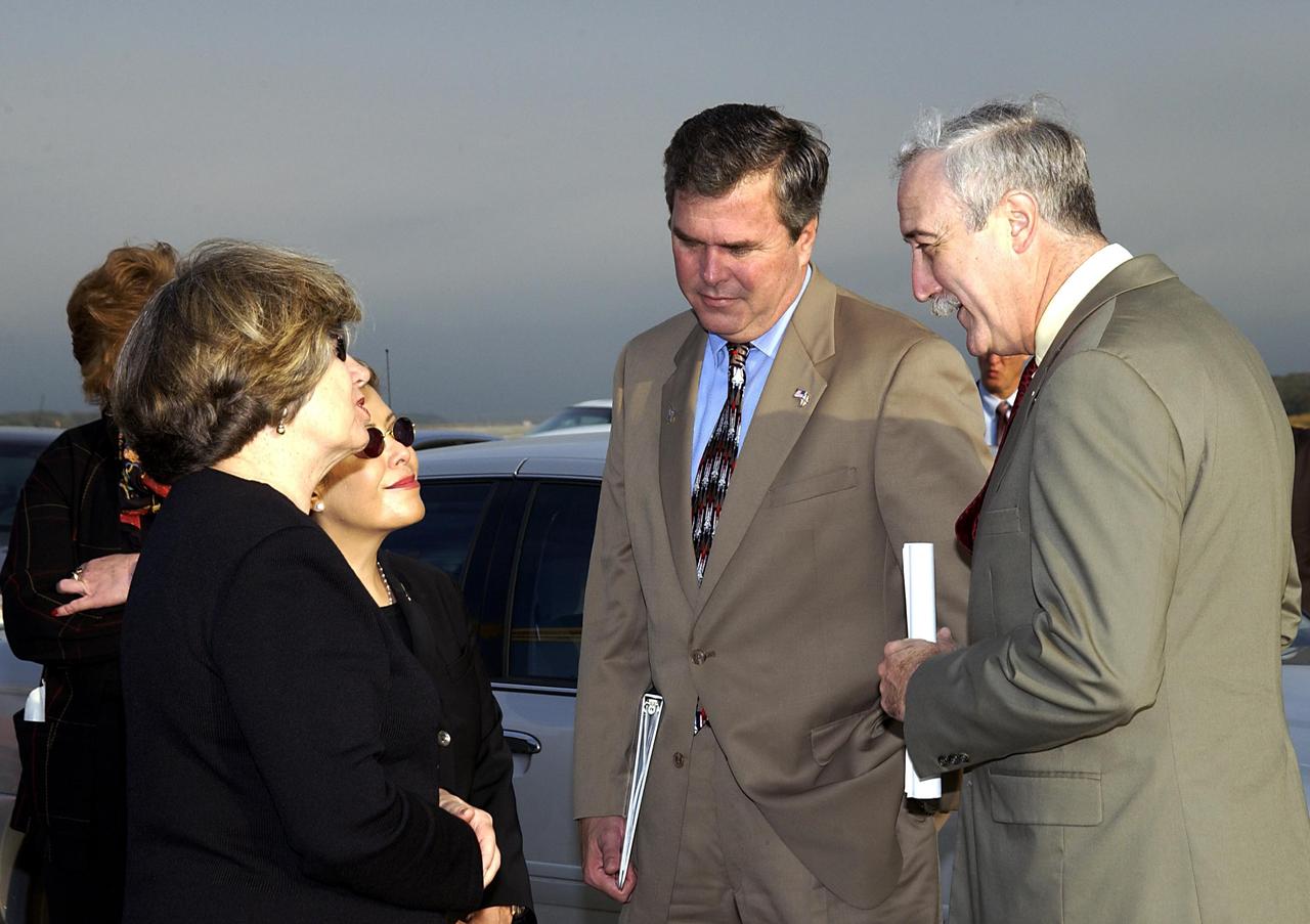 KENNEDY SPACE CENTER, FLA. -  A Columbia Crew Memorial Service is held at the Shuttle Landing Facility for KSC employees and invited guests, including Florida Gov. Jeb Bush (second from right) and NASA Administrator Sean O'Keefe (right). The Columbia and her crew of seven were lost on Feb. 1, 2003, over East Texas as they returned to Earth after a 16-day research mission.  Taking part in the service were NASA Administrator Sean O’Keefe, former KSC Director Robert Crippen, astronaut Jim Halsell, several employees, area clergymen, and members of Patrick Air Force Base.  The service concluded with a “Missing Man Formation Fly Over” by NASA T-38 jet aircraft.