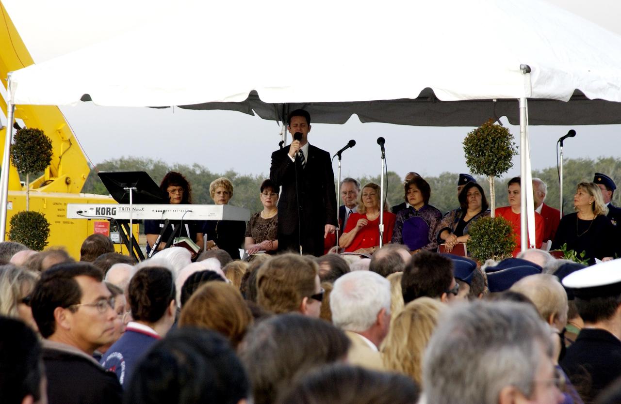 KENNEDY SPACE CENTER, FLA. -  A Columbia Crew Memorial Service is held at the Shuttle Landing Facility for KSC employees and invited guests. The Columbia and her crew of seven were lost on Feb. 1, 2003, over East Texas as they returned to Earth after a 16-day research mission.  Taking part in the service were NASA Administrator Sean O’Keefe, former KSC Director Robert Crippen, astronaut Jim Halsell, several employees, area clergymen, and members of Patrick Air Force Base.  The service concluded with a “Missing Man Formation Fly Over” by NASA T-38 jet aircraft.