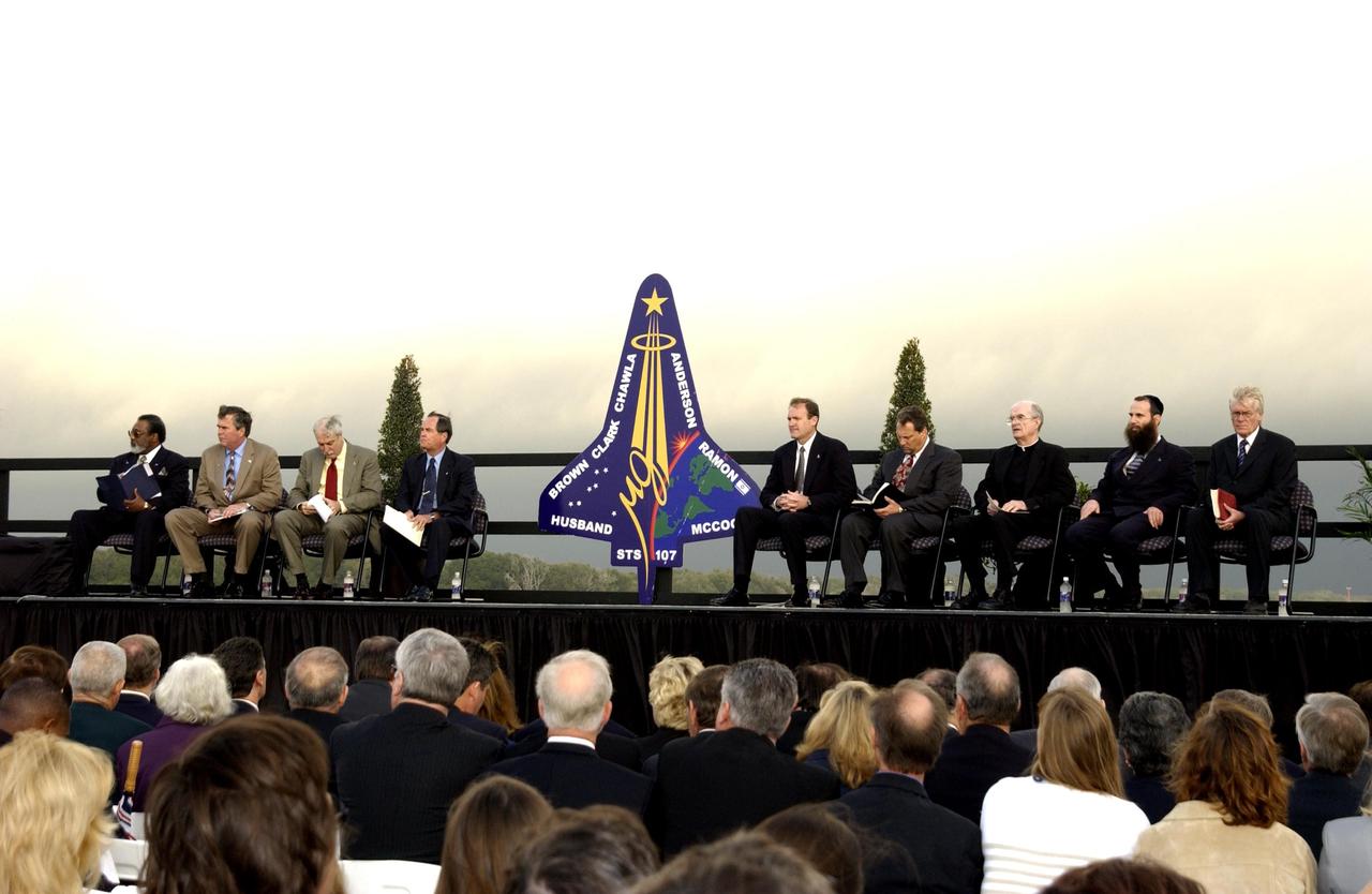 KENNEDY SPACE CENTER, FLA. -  A Columbia Crew Memorial Service is held at the Shuttle Landing Facility for KSC employees and invited guests. The Columbia and her crew of seven were lost on Feb. 1, 2003, over East Texas as they returned to Earth after a 16-day research mission.  Taking part in the service were NASA Administrator Sean O’Keefe, former KSC Director Robert Crippen, astronaut Jim Halsell, several employees, area clergymen, and members of Patrick Air Force Base.  The service concluded with a “Missing Man Formation Fly Over” by NASA T-38 jet aircraft.