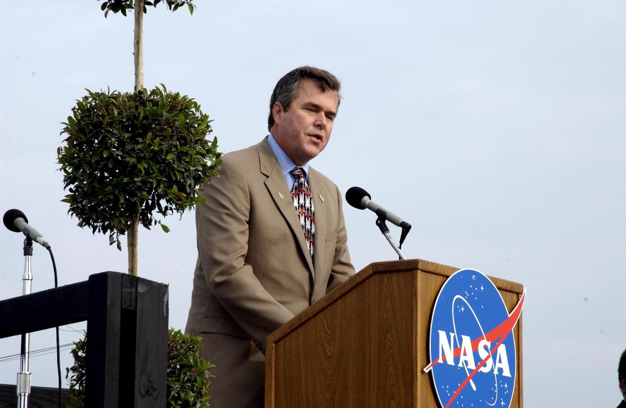 KENNEDY SPACE CENTER, FLA. -  A Columbia Crew Memorial Service is held at the Shuttle Landing Facility for KSC employees and invited guests.  Florida Gov. Jeb Bush is at the podium. The Columbia and her crew of seven were lost on Feb. 1, 2003, over East Texas as they returned to Earth after a 16-day research mission.  Taking part in the service were NASA Administrator Sean O’Keefe, former KSC Director Robert Crippen, astronaut Jim Halsell, several employees, area clergymen, and members of Patrick Air Force Base.  The service concluded with a “Missing Man Formation Fly Over” by NASA T-38 jet aircraft.