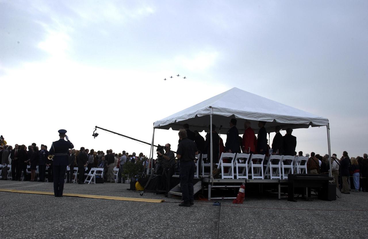 KENNEDY SPACE CENTER, FLA. -  A Columbia Crew Memorial Service is held at the Shuttle Landing Facility for KSC employees and invited guests.   The service concluded with a “Missing Man Formation Fly Over” by NASA T-38 jet aircraft, seen here. The Columbia and her crew of seven were lost on Feb. 1, 2003, over East Texas as they returned to Earth after a 16-day research mission.  Taking part in the service were NASA Administrator Sean O’Keefe, former KSC Director Robert Crippen, astronaut Jim Halsell, several employees, area clergymen, and members of Patrick Air Force Base.  