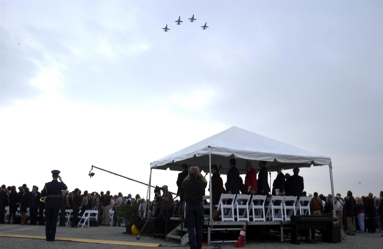 KENNEDY SPACE CENTER, FLA. -  A Columbia Crew Memorial Service is held at the Shuttle Landing Facility for KSC employees and invited guests.  The service concluded with a “Missing Man Formation Fly Over” by NASA T-38 jet aircraft, seen here.  The Columbia and her crew of seven were lost on Feb. 1, 2003, over East Texas as they returned to Earth after a 16-day research mission.  Taking part in the service were NASA Administrator Sean O’Keefe, former KSC Director Robert Crippen, astronaut Jim Halsell, several employees, area clergymen, and members of Patrick Air Force Base.  