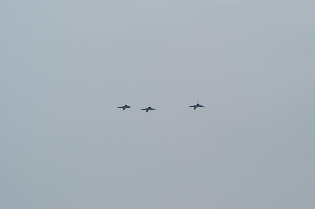 NASA T-38 jet aircraft are flying in a "Missing Man Formation" to conclude the memorial service for the crew of Columbia who were lost on Feb. 1, 2003, over East Texas as they returned to Earth after a 16-day research mission STS-107. The service was held at the Shuttle Landing Facility. Taking part in the service were NASA Administrator Sean O'Keefe, former KSC Director Robert Crippen, astronaut Jim Halsell, several employees, area clergymen, and members of Patrick Air Force Base. Crippen was the first to fly Columbia in 1981; Halsell first flew Columbia in 1994 and again in 1997. 