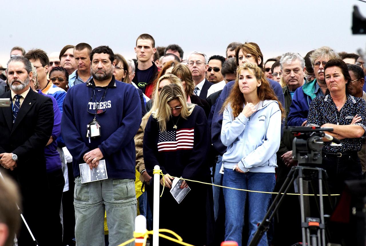 KENNEDY SPACE CENTER, FLA. --  Employees at KSC give solemn attention to the memorial service for the Columbia crew held at the Shuttle Landing Facility.  The crew were lost on Feb. 1, 2003, over East Texas as they returned to Earth after the 16-day research mission STS-107. Taking part in the service were NASA Administrator Sean O'Keefe, former KSC Director Robert Crippen, astronaut Jim Halsell, several employees, area clergymen, and members of Patrick Air Force Base.  Crippen was the first to fly Columbia in 1981; Halsell first flew Columbia in 1994 and again in 1997.  